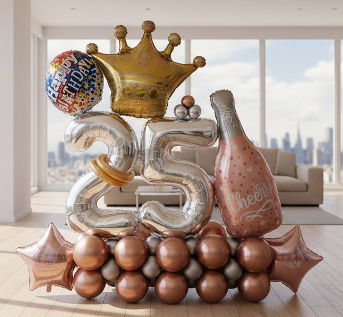 A Birthday balloon bouquet featuring a variety of balloons including number balloons, a crown, and others with cheerful messages, arranged together.