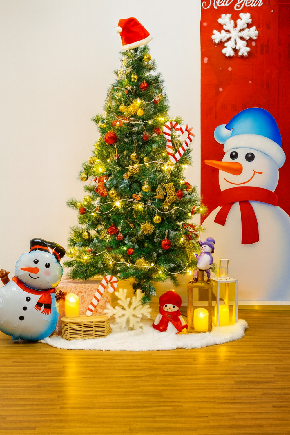 Christmas decoration setup with a decorated tree, snowman, fairy lights, ornaments, and festive props.