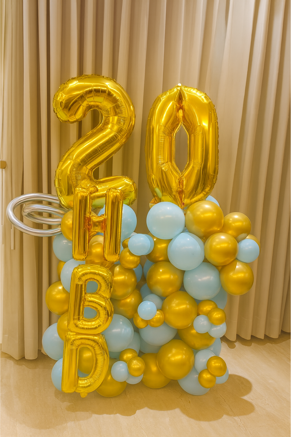 Customizable balloon decoration with gold and blue balloons and personalized foil numbers and letters.