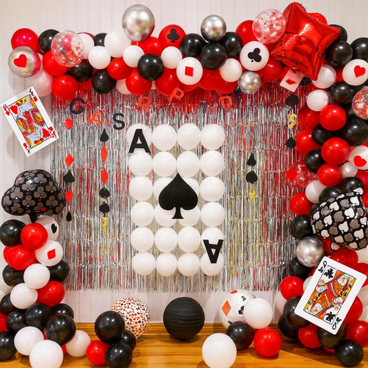 Casino-themed balloon decoration backdrop with red, black, white, and silver balloons, featuring playing card symbols and Ace of Spades design for party or event décor.