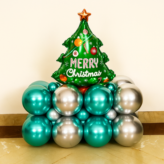 Christmas surprise balloon bouquet featuring a festive tree foil balloon displayed on a base of teal and silver balloons.