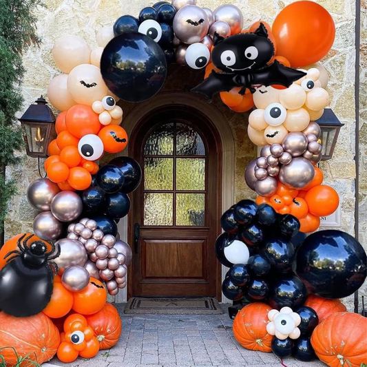 Halloween balloon arch with black, orange and metallic balloons decorated with pumpkins, bats and spider for party entrance décor.