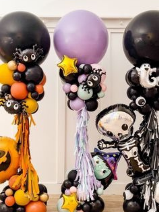 Halloween balloon columns with ghosts, spiders, skeleton, star balloons and pastel accents for party decoration.