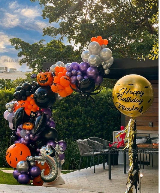 Halloween birthday balloon arch decoration with pumpkins, ghost, bats, spider and colorful balloons for party celebrations.