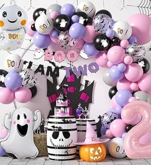 Halloween birthday decoration with pastel balloons, ghost cutouts, pumpkin props and spooky backdrop for kids’ party setup.