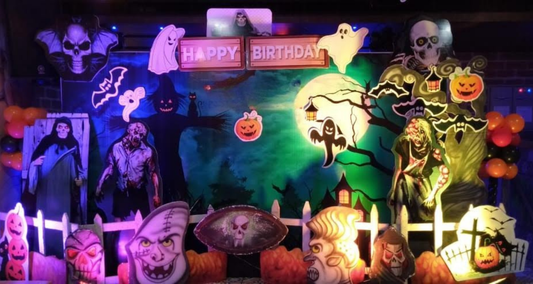 Halloween birthday backdrop decoration with zombies, ghosts, bats, and pumpkins for a spooky party theme.