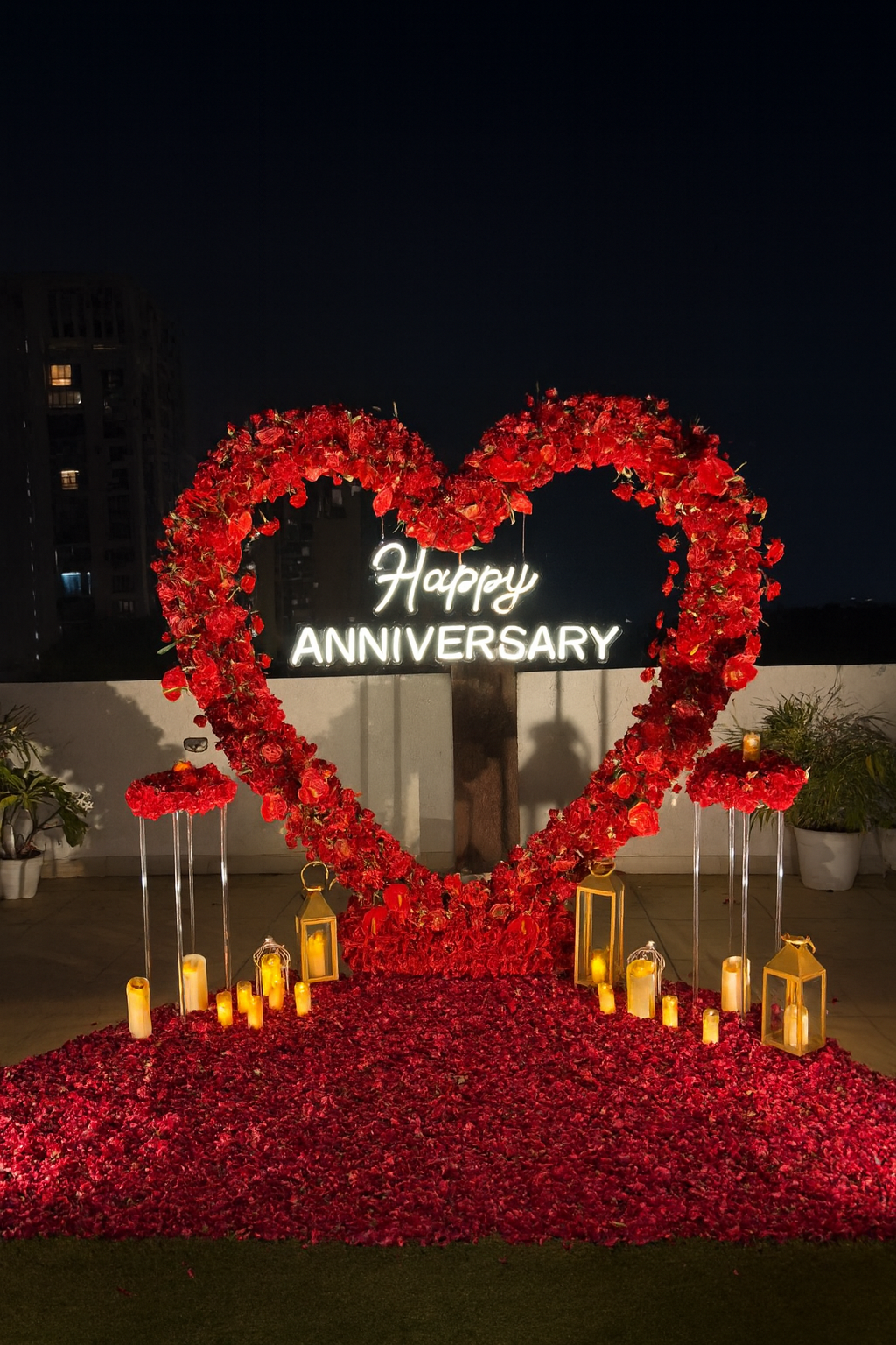 Romantic Happy Anniversary Rooftop Decoration with Heart Floral Arch & Candlelight Setup